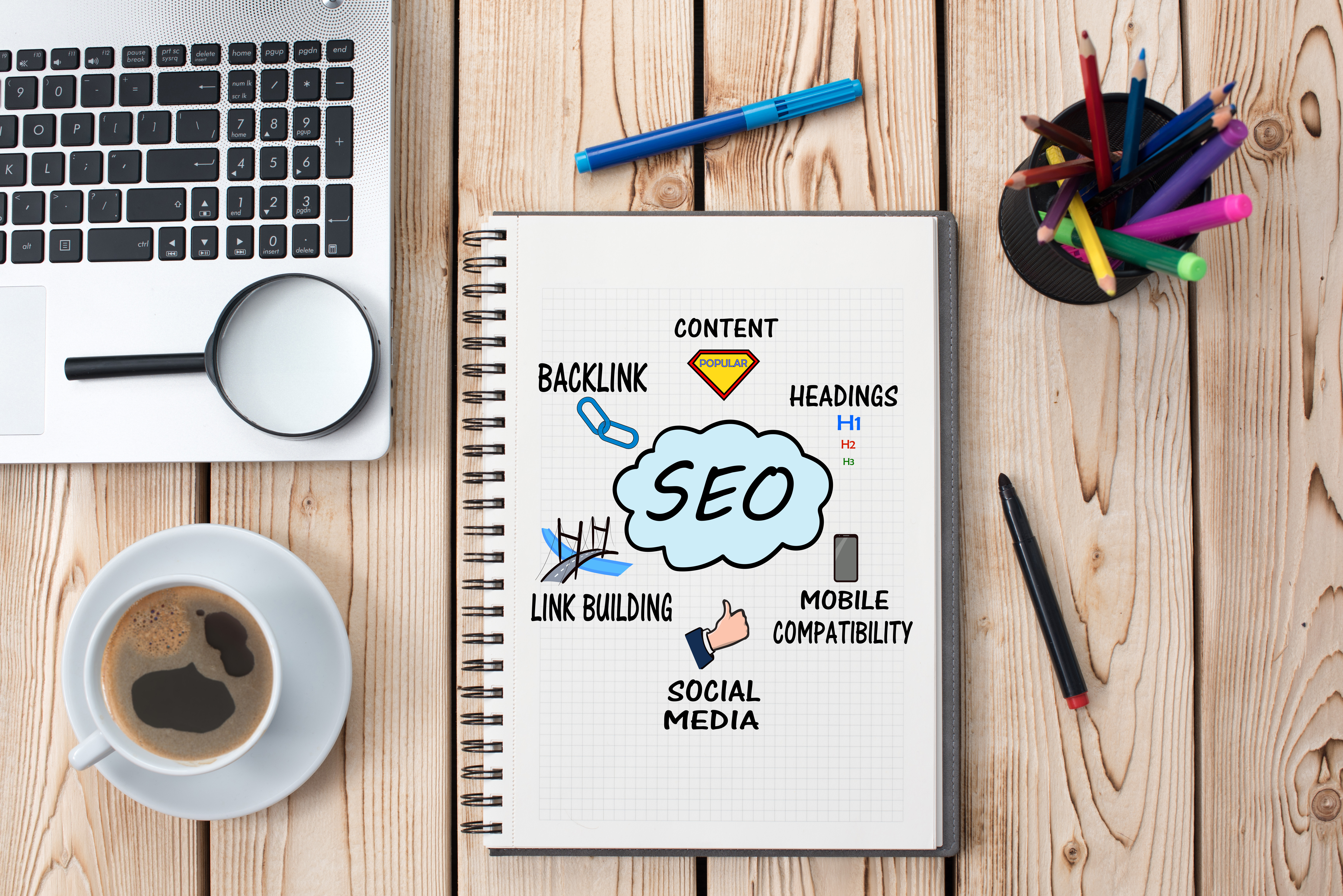 Desk with notepad with SEO outline